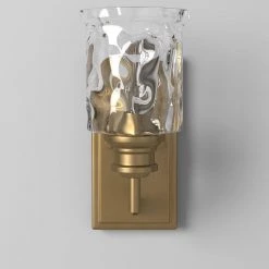 5 in. Drake 1-Light Brushed Gold Industrial Wall Mount Sconce Light with Clear Hammered Glass Shade by Designers Fountain 16 5 in. Drake 1-Light Brushed Gold Industrial Wall Mount Sconce Light with Clear Hammered Glass Shade by Designers Fountain -Designers Fountain Shop brushed gold designers fountain vanity lighting 96301 bg 4f 1000