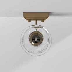 5 in. Drake 1-Light Brushed Gold Industrial Wall Mount Sconce Light with Clear Hammered Glass Shade by Designers Fountain 19 5 in. Drake 1-Light Brushed Gold Industrial Wall Mount Sconce Light with Clear Hammered Glass Shade by Designers Fountain -Designers Fountain Shop brushed gold designers fountain vanity lighting 96301 bg fa 1000