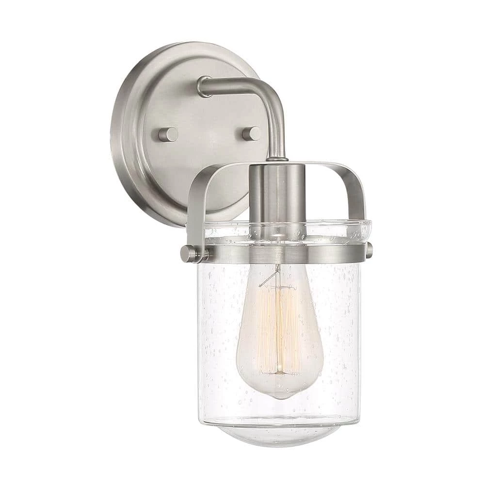6 in. Jaxon 1-Light Brushed Nickel Industrial Wall Mount Sconce Light with Clear Seedy Glass Shade by Designers Fountain 3 6 in. Jaxon 1-Light Brushed Nickel Industrial Wall Mount Sconce Light with Clear Seedy Glass Shade by Designers Fountain