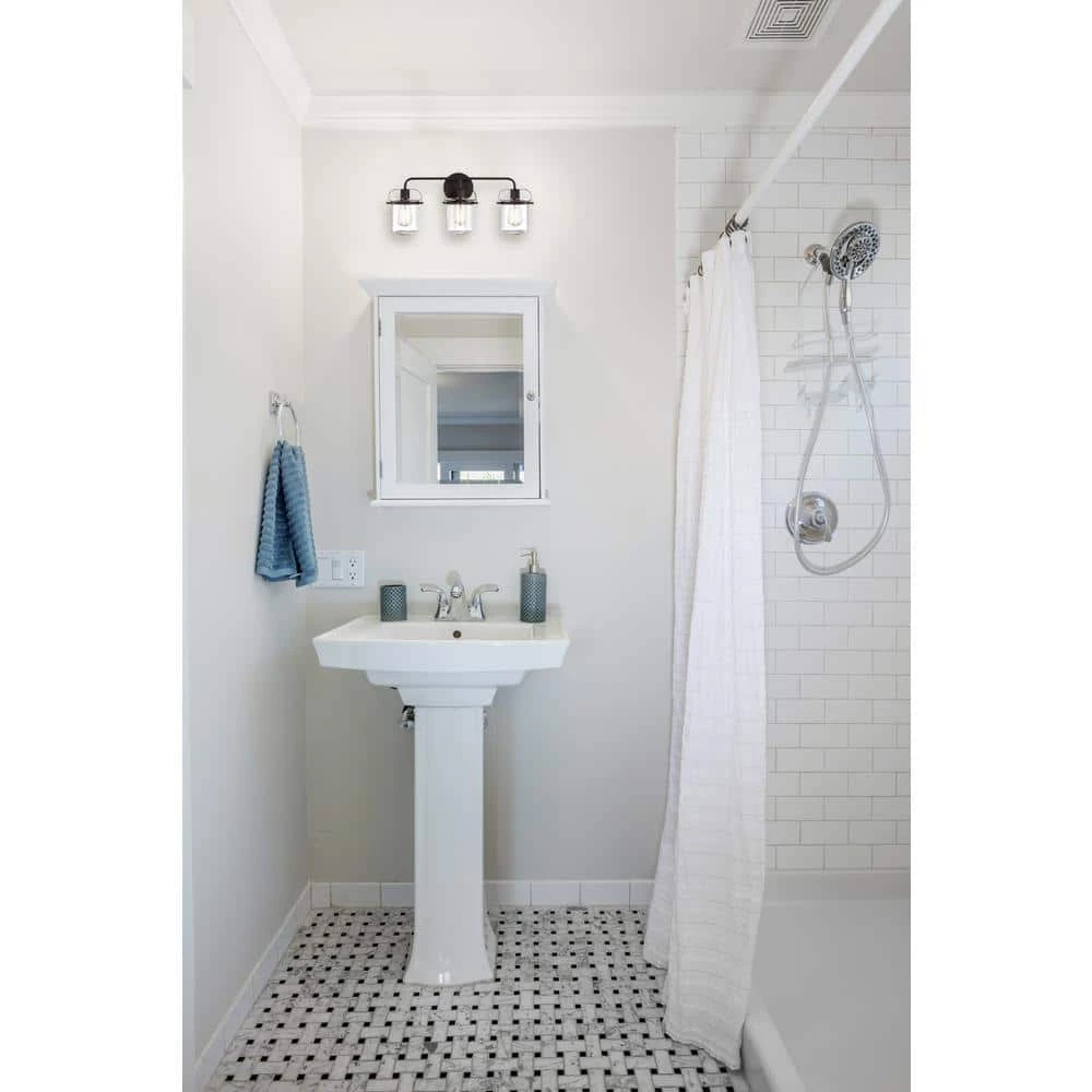 24 in. Jaxon 3-Light Oil Rubbed Bronze Industrial Bathroom Vanity Light with Clear Glass Shade by Designers Fountain 4 24 in. Jaxon 3-Light Oil Rubbed Bronze Industrial Bathroom Vanity Light with Clear Glass Shade by Designers Fountain - Image 2