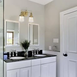 15.25 in. Taylor 2-Light Old Satin Brass Industrial Bathroom Vanity Light with Clear Glass Shades by Designers Fountain -Designers Fountain Shop old satin brass designers fountain vanity lighting 69502 osb 1f 1000